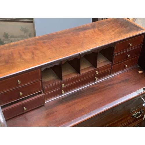 776 - A 19th century mahogany and satinwood banded bureau, fall front over four graduating drawers on brac... 