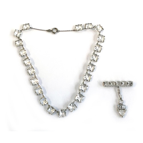 20 - An Art Deco white metal and square paste riviere necklace, mounted in white metal, fastening with a ... 