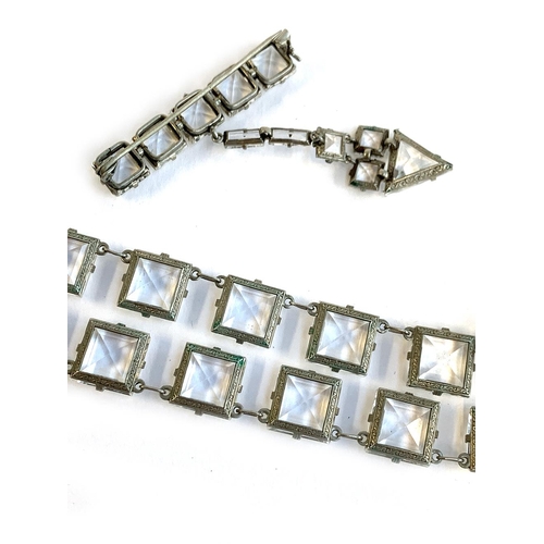 20 - An Art Deco white metal and square paste riviere necklace, mounted in white metal, fastening with a ... 