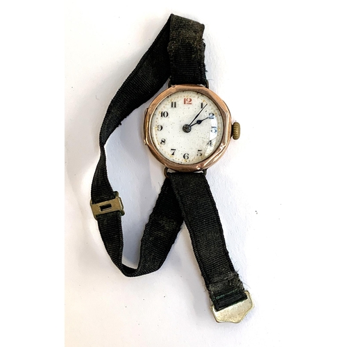 61 - An early 20th century 9ct gold cased Swiss jewelled lever wristwatch on a black fabric strap, hallma... 