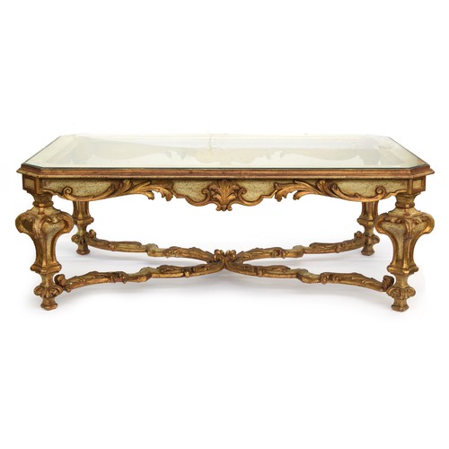 721A - A painted and parcel gilt glass topped coffee table, the carved apron with gilt acanthus decoration,... 