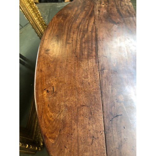 636 - A George III mahogany wake table, the top with hinged drop leaves, on eight moulded square section l... 