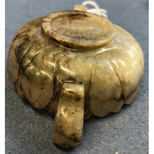 177 - A Chinese mutton fat and mottled grey jade twin handled cup, of shallow lotus form with twin dragon ... 