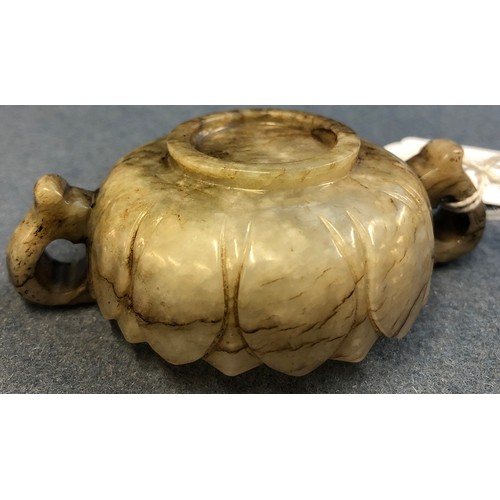 177 - A Chinese mutton fat and mottled grey jade twin handled cup, of shallow lotus form with twin dragon ... 