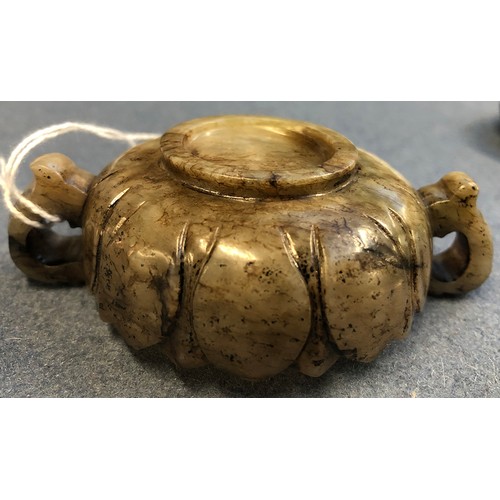 177 - A Chinese mutton fat and mottled grey jade twin handled cup, of shallow lotus form with twin dragon ... 