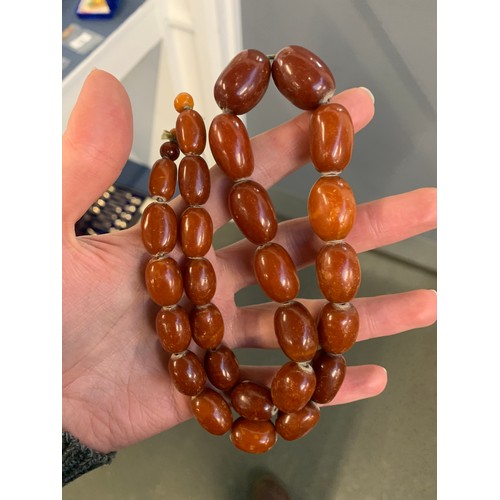 18 - A graduated cognac amber bead necklace, approx. 59g, 57cm long