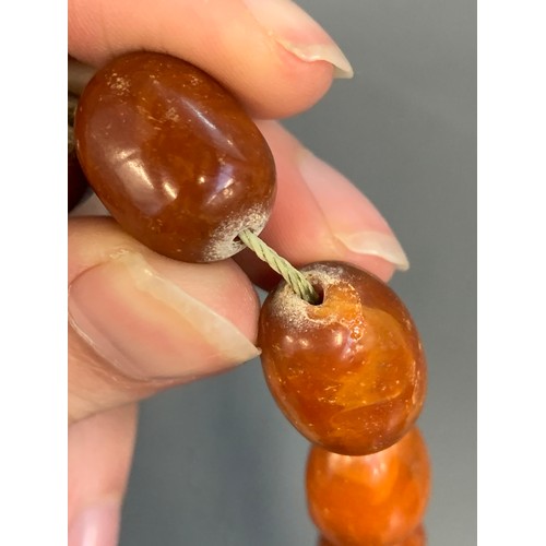 18 - A graduated cognac amber bead necklace, approx. 59g, 57cm long