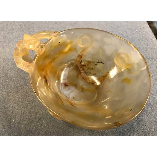 175 - Two Chinese translucent agate libation cups, each with handle in the form of a climbing tiger, the s... 