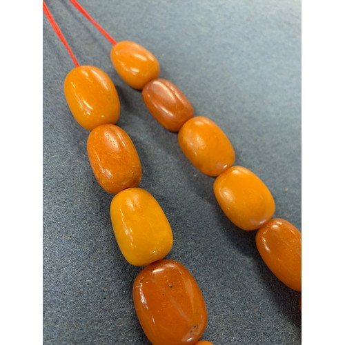 19 - Two butterscotch amber graduated bead necklaces, one necklace 17 beads, the other 15, the largest be... 