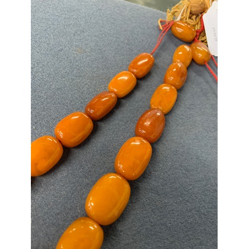 19 - Two butterscotch amber graduated bead necklaces, one necklace 17 beads, the other 15, the largest be... 