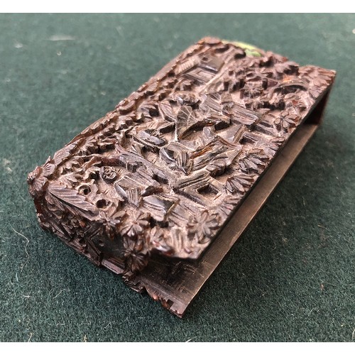 172 - A Chinese tortoiseshell card case of rectangular form, carved in relief with figures on a terrace am... 