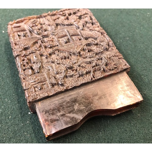 172 - A Chinese tortoiseshell card case of rectangular form, carved in relief with figures on a terrace am... 