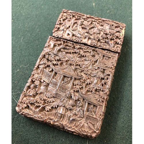 172 - A Chinese tortoiseshell card case of rectangular form, carved in relief with figures on a terrace am... 