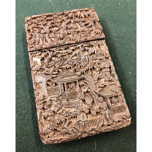 172 - A Chinese tortoiseshell card case of rectangular form, carved in relief with figures on a terrace am... 