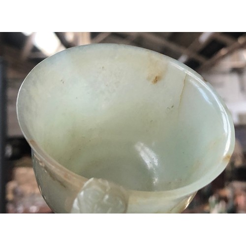 178 - A Chinese celadon and russet jade libation cup, the handle in the form of a dragon, 4cm high