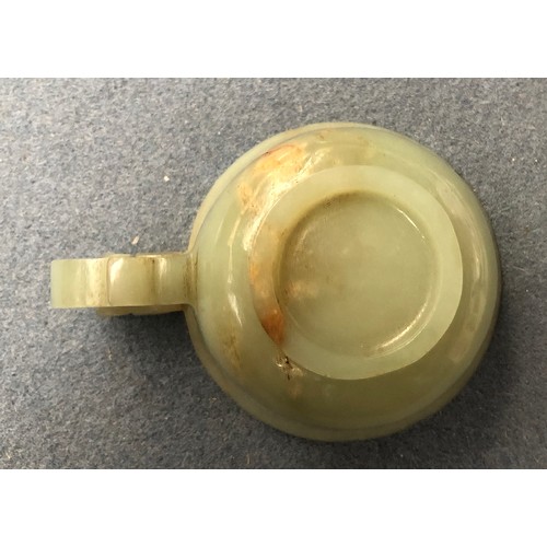 178 - A Chinese celadon and russet jade libation cup, the handle in the form of a dragon, 4cm high