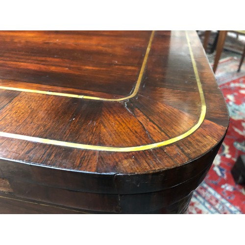 603 - A George IV rosewood and brass inlaid card table, c.1825, the folding top enclosing a baize playing ... 