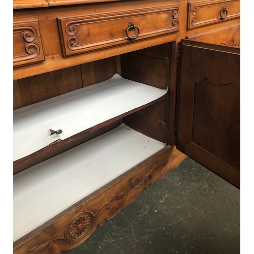 560 - A very large French walnut sideboard in 18th century style, having four drawers over four cupboard d... 