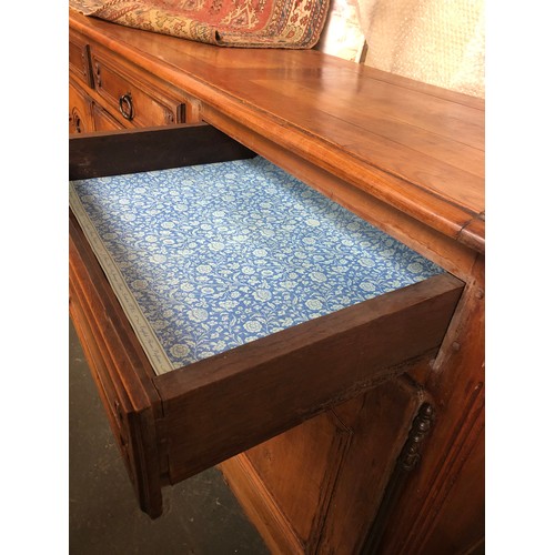 560 - A very large French walnut sideboard in 18th century style, having four drawers over four cupboard d... 