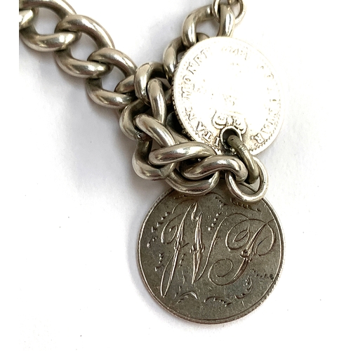 10 - A silver charm bracelet (clasp af), to include Victorian silver penny engraved JVP, Winchester cathe... 