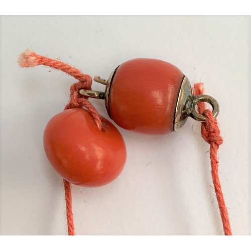 17 - A 19th century coral bead necklace (in need of restringing), each bead approx. 1cmD, with yellow met... 