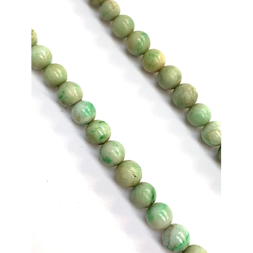 23 - An early 20th century graduated jade bead single strand necklace, with gold bolt clasp, 43cmL (with ... 