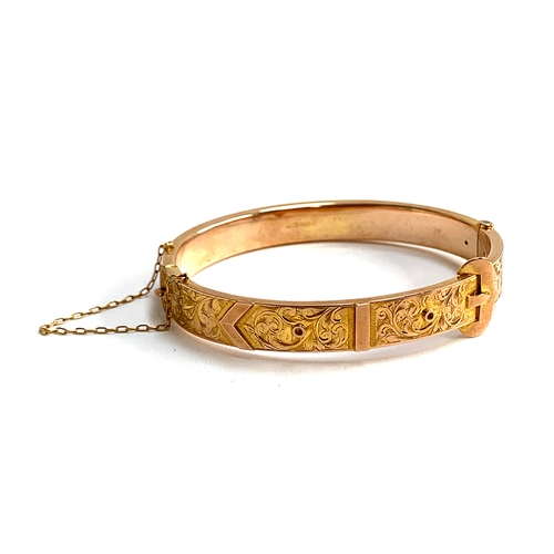 32 - An Edwardian 9ct gold bangle of buckle form, foliate engraved decoration, with safety chain, hallmar... 