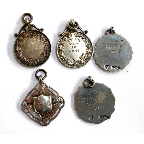 43 - A collection of five 1930's silver football medals: Eastern Suburban Football League 2nd Div. 1935-3... 