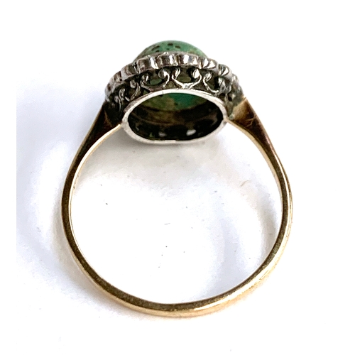 7 - An early 20th century gold ring set with a turquoise cabochon surrounded by paste (one stone missing... 