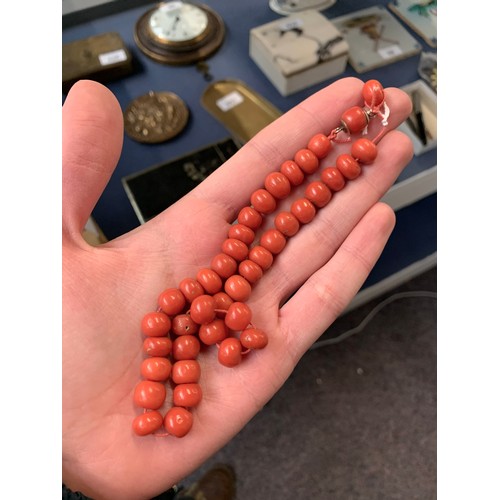 17 - A 19th century coral bead necklace (in need of restringing), each bead approx. 1cmD, with yellow met... 