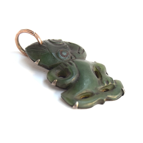 39 - A 19th century Maori Hei Tiki pounamu nephrite pendant, four overall perforations, well carved with ... 