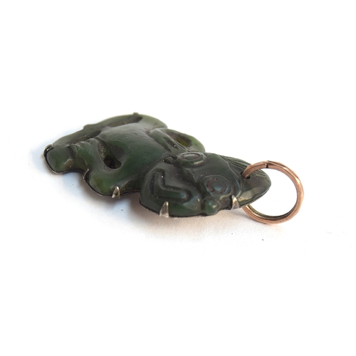 39 - A 19th century Maori Hei Tiki pounamu nephrite pendant, four overall perforations, well carved with ... 