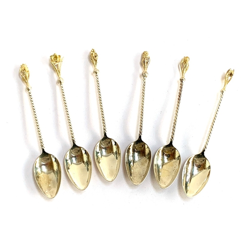 18 - A set of six .925 silver teaspoons, each with silver gilt floral terminal