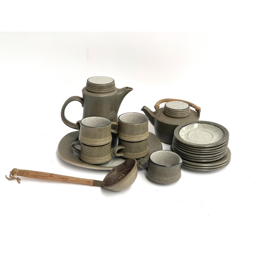 66 - A stoneware teapot, coffee pot, 4 cups, milk jug, tray, 10 plates and a studio pottery ladle