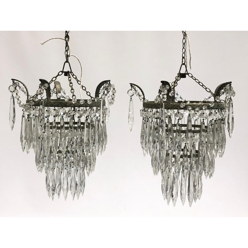 155 - A pair of three tier glass drop chandeliers, approx. 28cm long, together with a four tier chandelier... 