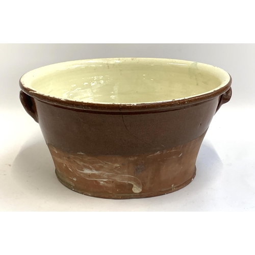 79 - A 19th century terracotta glazed dairy bowl, 49cmD, 23cmH