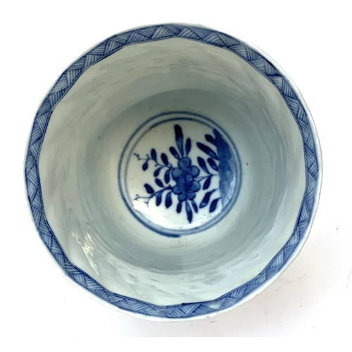 84 - A Chinese blue and white cup decorated with floral panels, marked to base with a flower in double bl... 