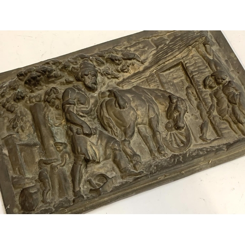 199 - A heavy cast metal plaque depicting a pastoral scene, 24x38cm, together with a carved soapstone seal