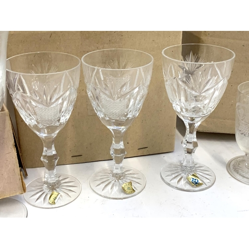 91 - A quantity of cut and etched glass to include a pair of Waterford crystal goblets with engraved swag... 