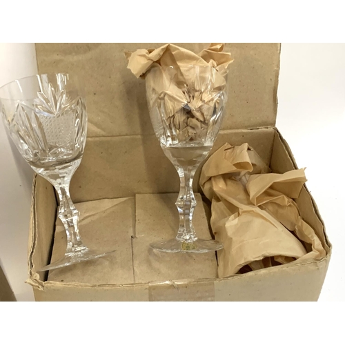 91 - A quantity of cut and etched glass to include a pair of Waterford crystal goblets with engraved swag... 