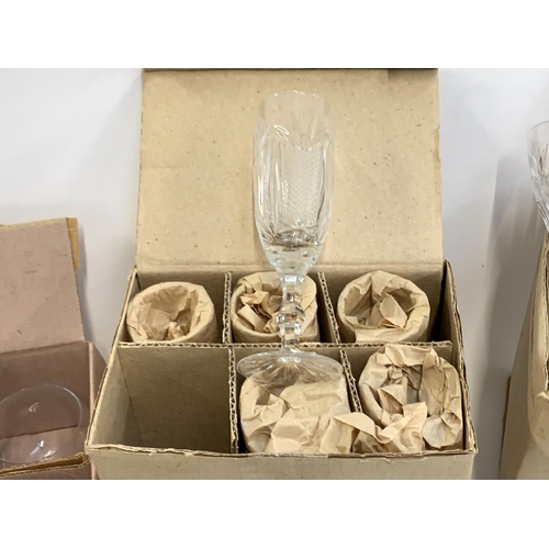 91 - A quantity of cut and etched glass to include a pair of Waterford crystal goblets with engraved swag... 