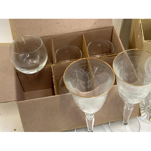 91 - A quantity of cut and etched glass to include a pair of Waterford crystal goblets with engraved swag... 