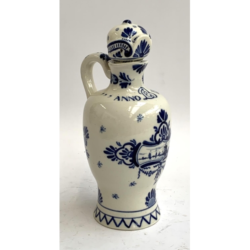 93 - An early 20th century Delft lidded jug, painted with windmill scene with script 'Anno 1575', date ma... 