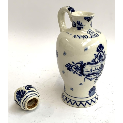 93 - An early 20th century Delft lidded jug, painted with windmill scene with script 'Anno 1575', date ma... 