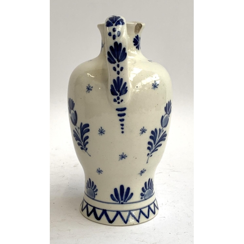 93 - An early 20th century Delft lidded jug, painted with windmill scene with script 'Anno 1575', date ma... 