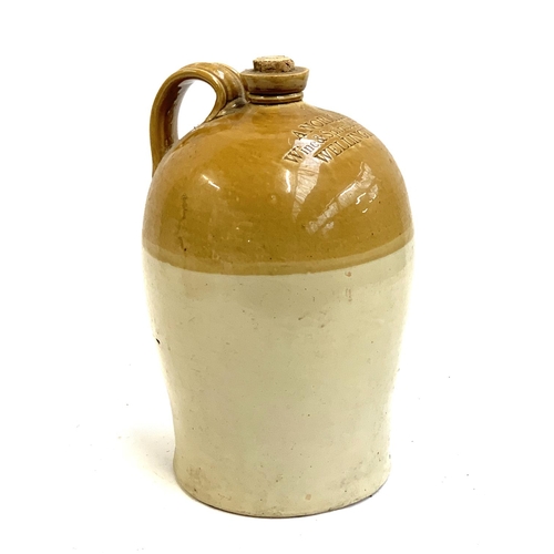 120 - A loop handled stoneware flagon by Powell, Bristol, stamped A Norman, Wine & Spirit Merchant, Wellin... 