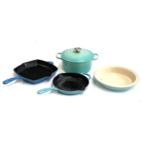 126 - Two Le Creuset cast iron skillets, together with a cast iron saucepan with lid and a stoneware dish,... 