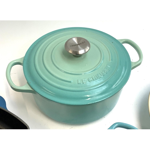 126 - Two Le Creuset cast iron skillets, together with a cast iron saucepan with lid and a stoneware dish,... 