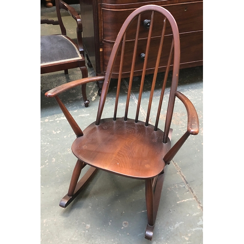 829 - An Ercol elm child's stickback rocking chair