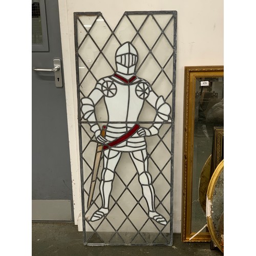 860 - A leaded stained glass panel depicting a knight in armour, 130x51cm